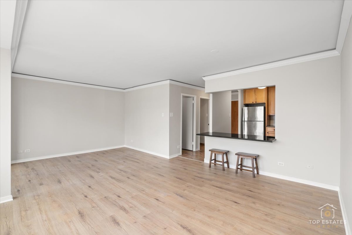 211 East Ohio Street, Unit 2806 Chicago, IL 60611 - Photo 6 of 33 a view of an empty room with wooden floor and a window