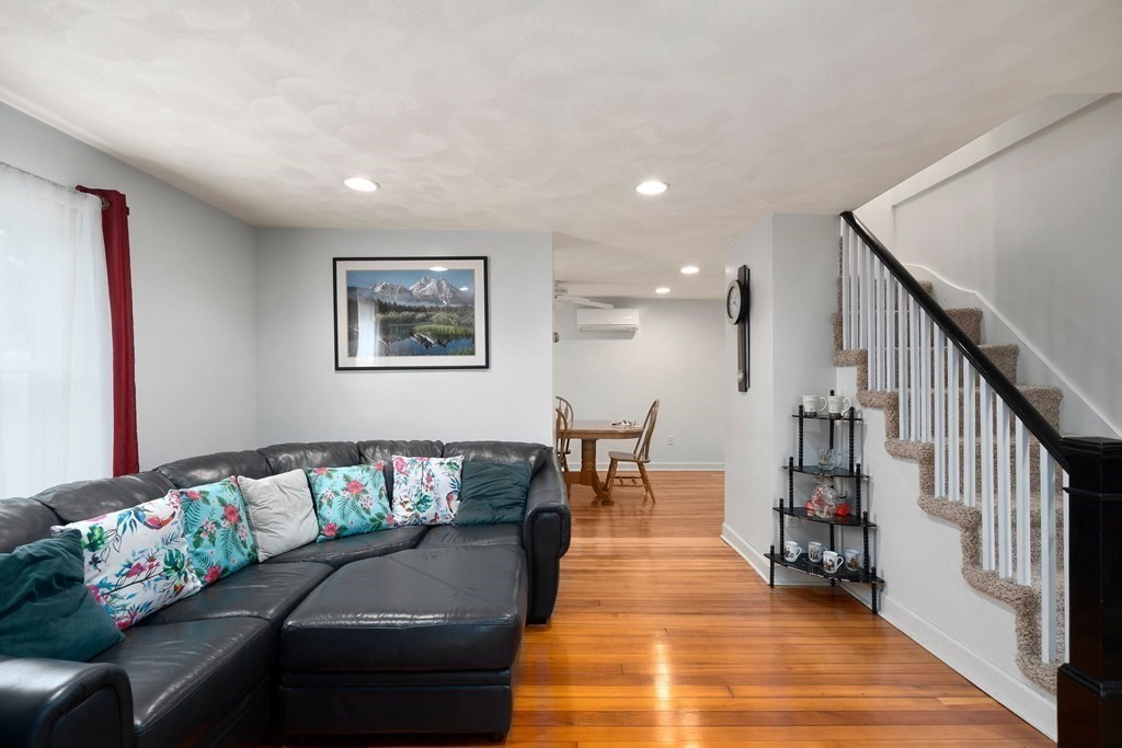 102 Orange Street Reading, MA 01867 - Photo 2 of 23 a living room with furniture and a dining table with wooden floor