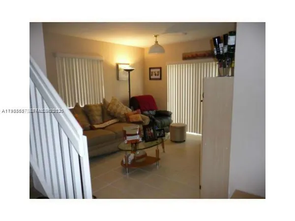 a kitchen with stainless steel appliances a stove a microwave a refrigerator and cabinets