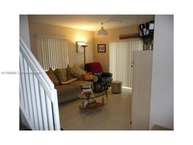 a kitchen with stainless steel appliances a stove a microwave a refrigerator and cabinets