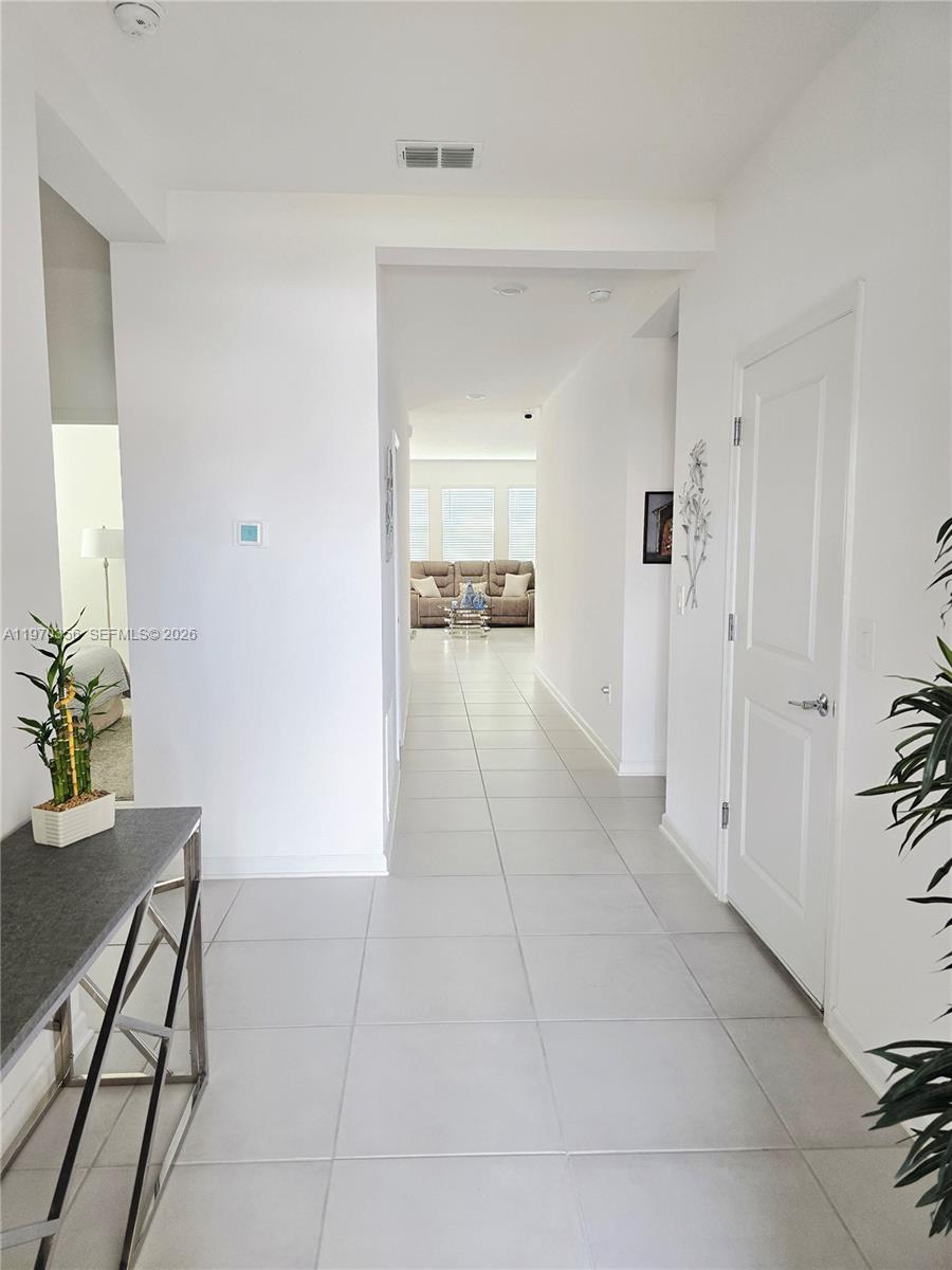 815 Kapi Drive Groveland, FL 34736 - Photo 13 of 30 a view of a hallway to dining room and livingroom with furniture