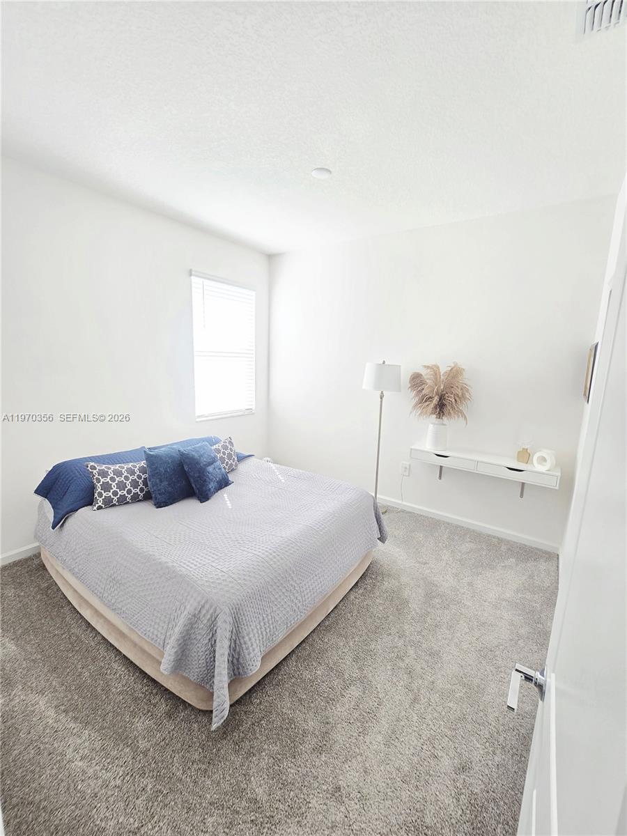 815 Kapi Drive Groveland, FL 34736 - Photo 14 of 30 a spacious bedroom with a bed and a window