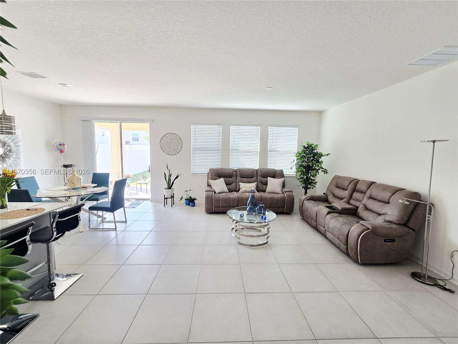 815 Kapi Drive Groveland, FL 34736 - Photo 21 of 30 a living room with furniture a large window and a table