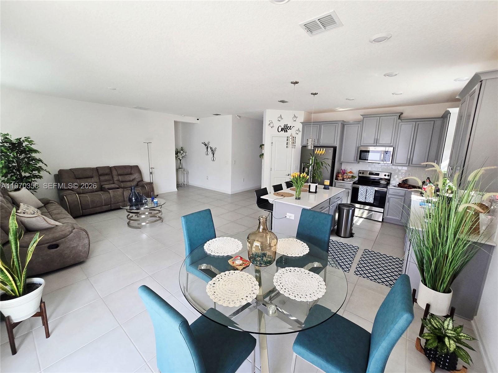 815 Kapi Drive Groveland, FL 34736 - Photo 24 of 30 a living room with furniture kitchen view and a potted plant