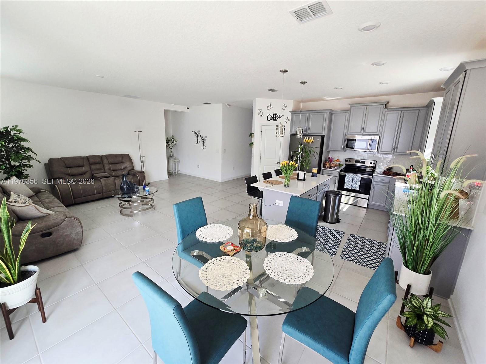 815 Kapi Drive Groveland, FL 34736 - Photo 25 of 30 a living room with furniture kitchen view and a potted plant