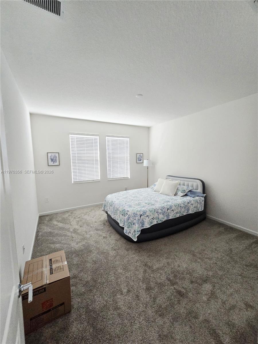 815 Kapi Drive Groveland, FL 34736 - Photo 26 of 30 a bedroom with a bed and a couch