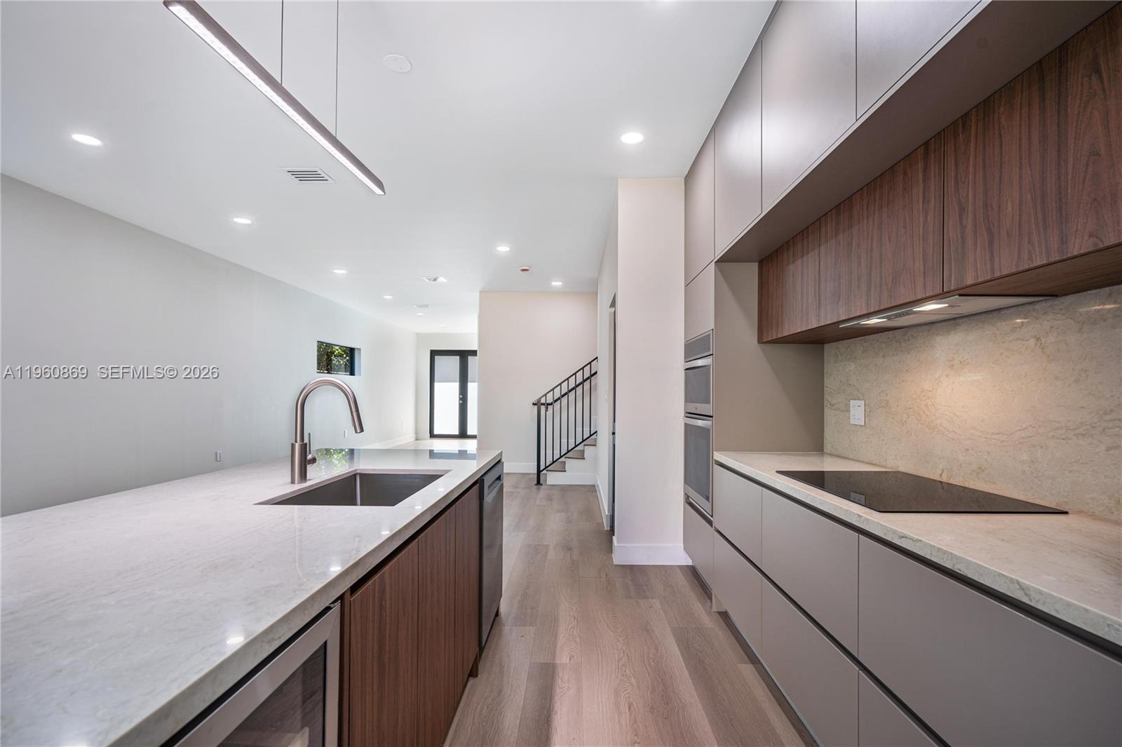 281 Northwest 52nd Street, Unit 281 Miami, FL 33127 - Photo 15 of 52 a kitchen with stainless steel appliances granite countertop a sink and stove