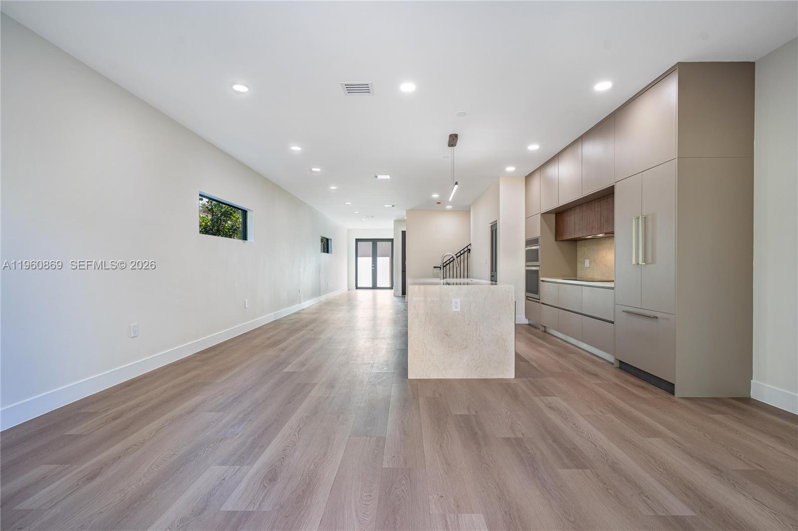 281 Northwest 52nd Street, Unit 281 Miami, FL 33127 - Photo 17 of 52 a view of a big room with wooden floor and windows