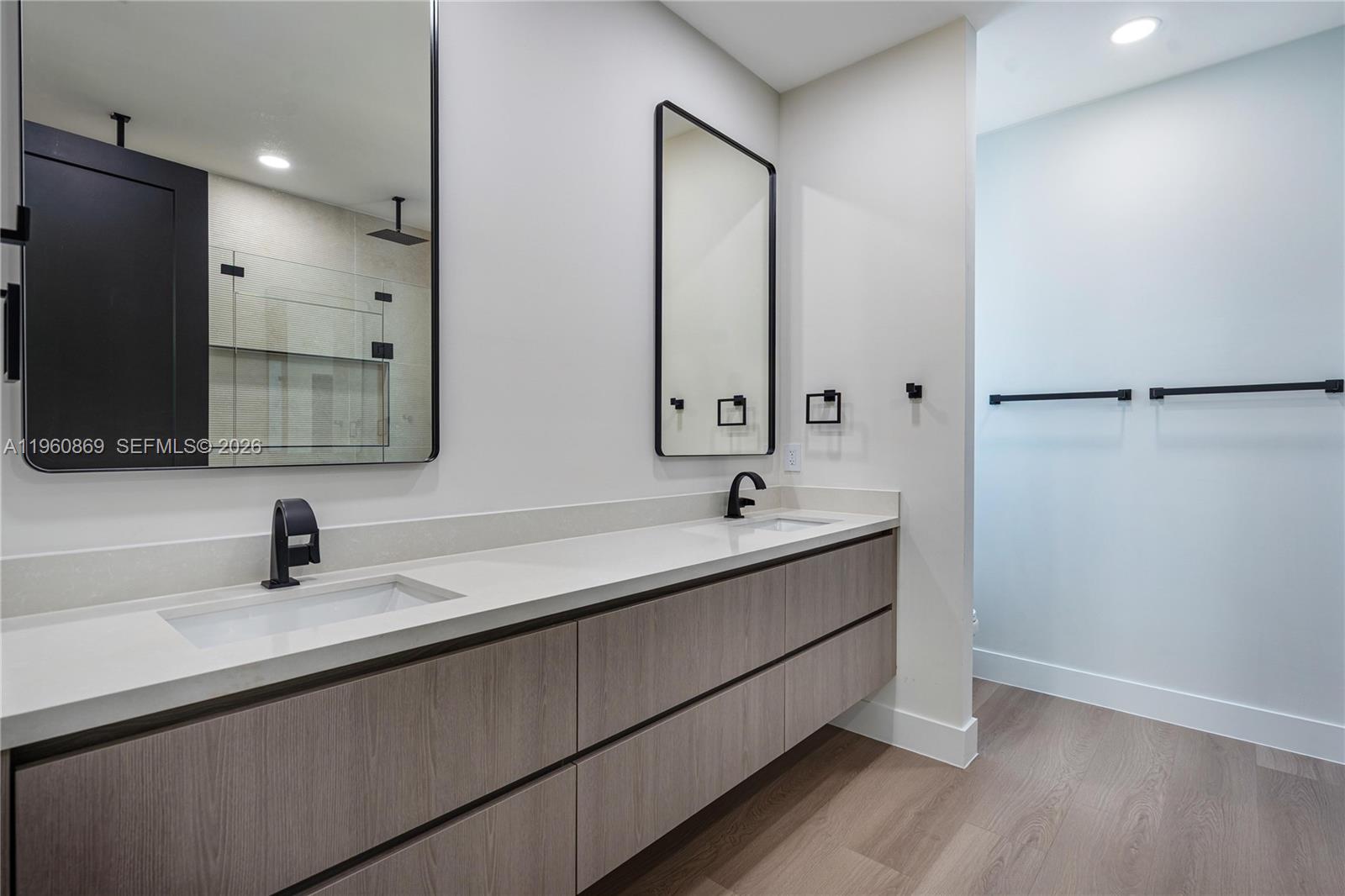 281 Northwest 52nd Street, Unit 281 Miami, FL 33127 - Photo 34 of 52 a bathroom with a double vanity sink and mirror