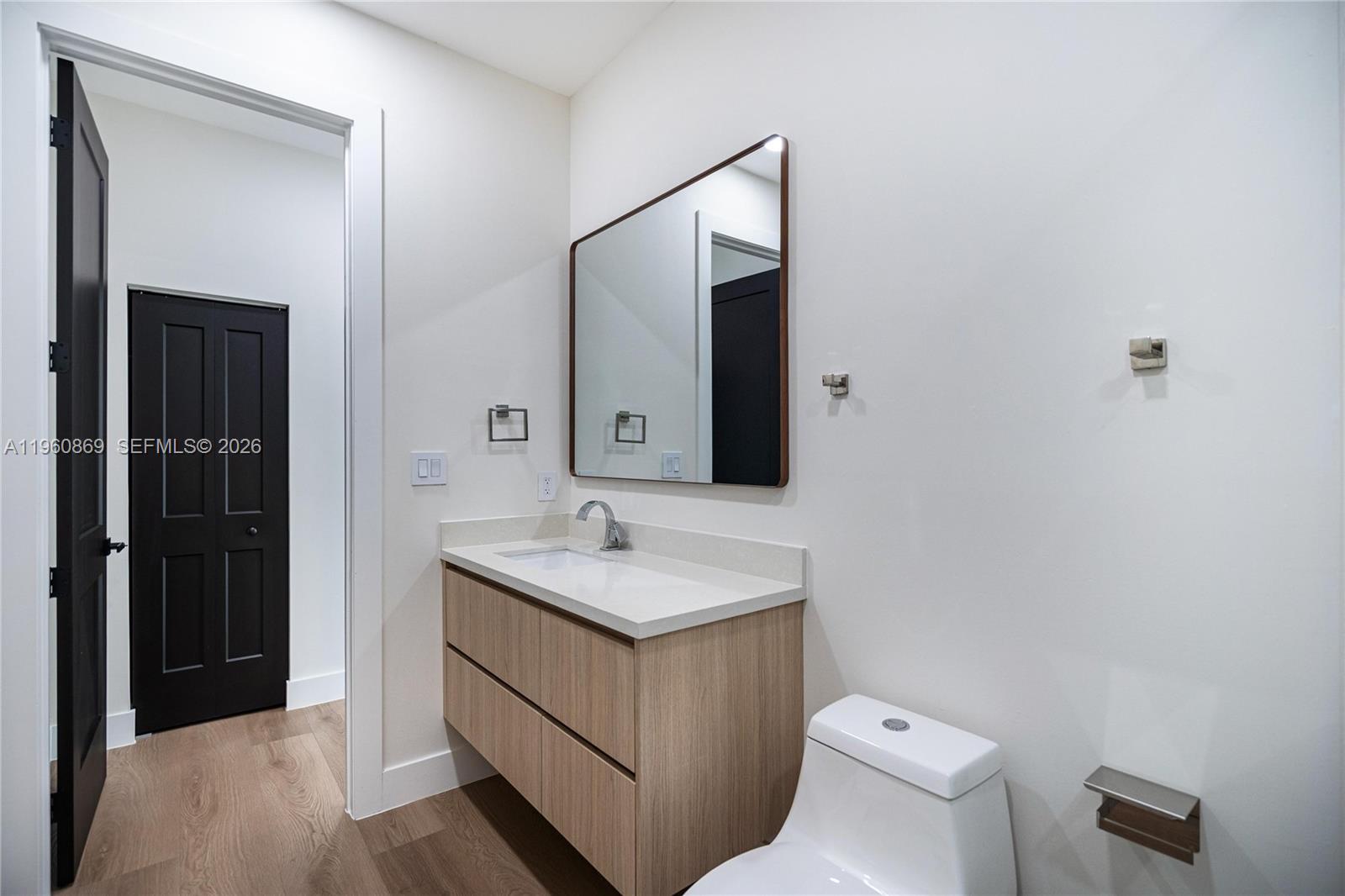 281 Northwest 52nd Street, Unit 281 Miami, FL 33127 - Photo 50 of 52 a bathroom with a toilet sink and mirror