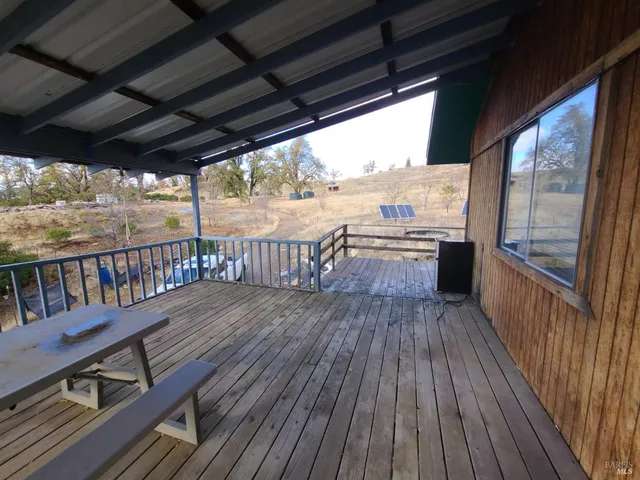 a view of a balcony with wooden floor