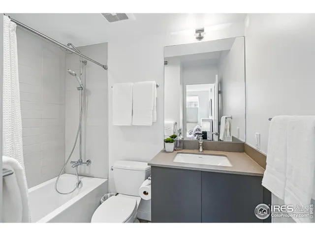 a bathroom with a sink vanity toilet and shower