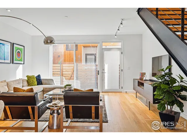 a living room with furniture a potted plant and a table