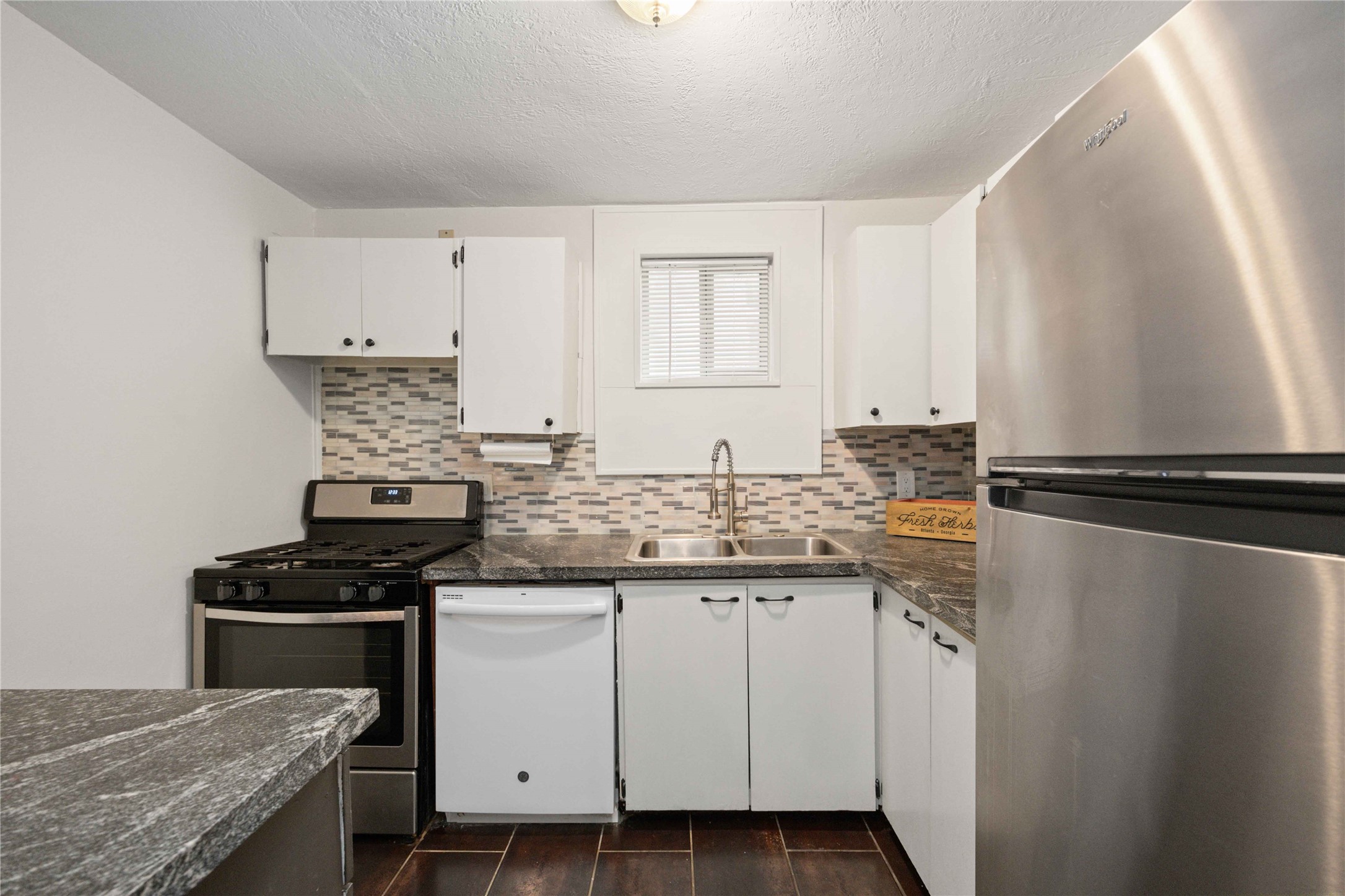 2503 Park Street Houston, TX 77098 - Photo 22 of 23 a kitchen with stainless steel appliances granite countertop a stove a sink and a refrigerator