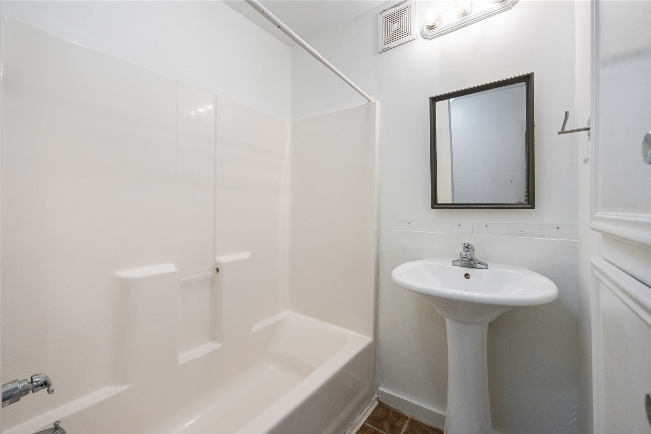 2503 Park Street Houston, TX 77098 - Photo 23 of 23 a bathroom with a sink a mirror and a bathtub