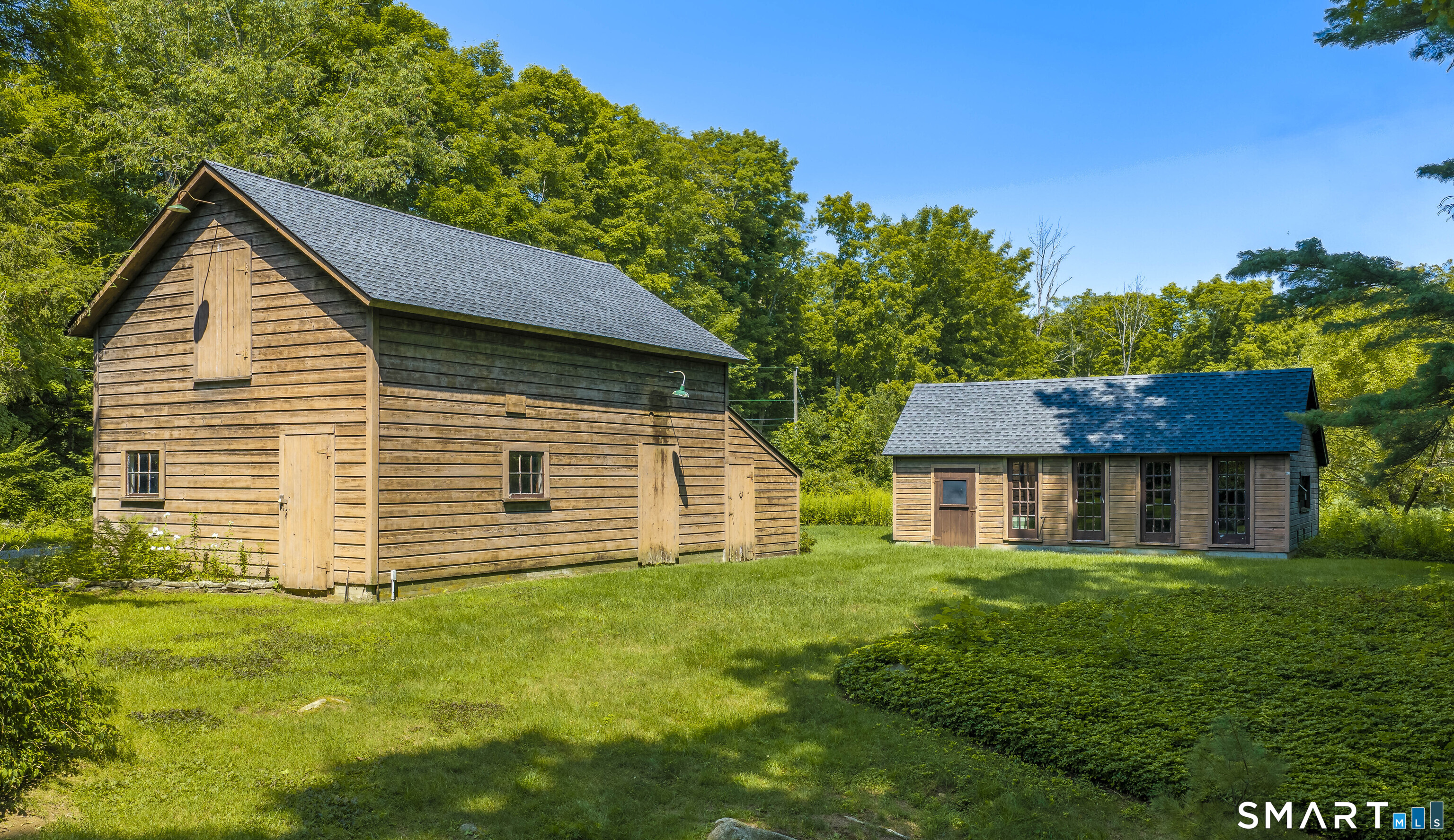The nearly 40-acre property reveals its full character through a collection of outbuildings.