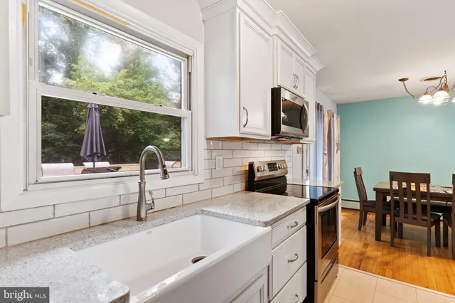 a kitchen with stainless steel appliances granite countertop a stove and a refrigerator