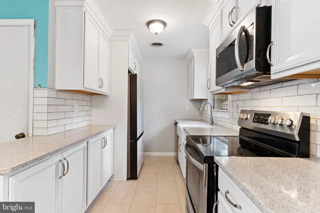 a bed sitting in a bedroom next to a window with fireplace