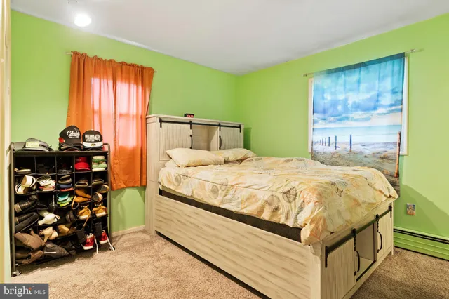 a bedroom with a bed and a dresser