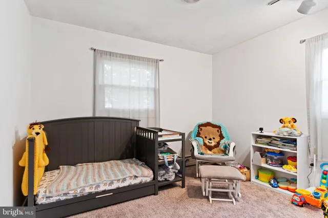 a living room with furniture and a book shelf