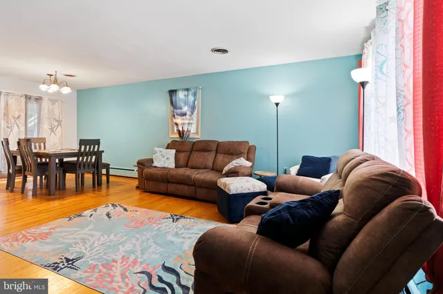 a living room with furniture and dining area