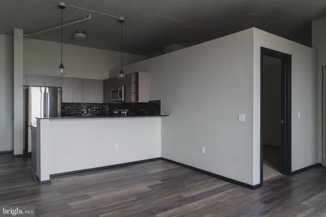 a view of a kitchen with wooden floor