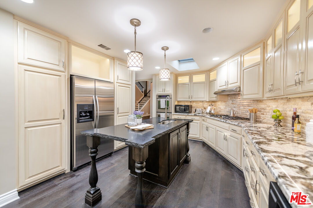 4500 Park Serena Calabasas, CA 91302 - Photo 14 of 34 a kitchen with stainless steel appliances granite countertop a sink a stove and a refrigerator