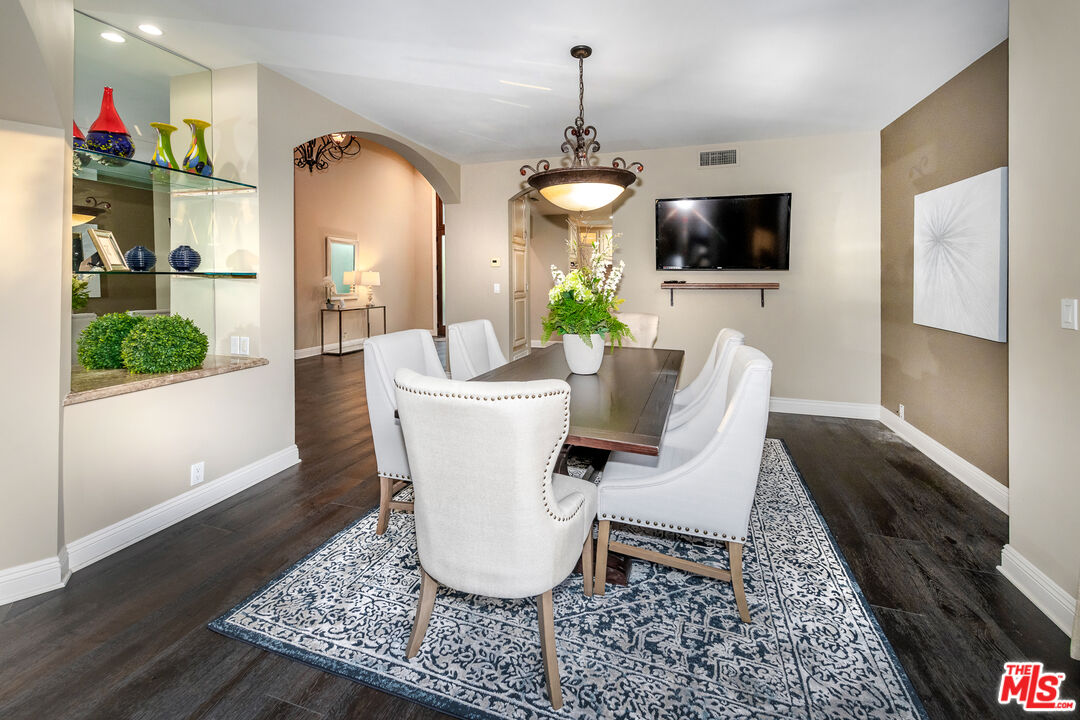 4500 Park Serena Calabasas, CA 91302 - Photo 15 of 34 a living room with furniture a flat screen tv and a dining table