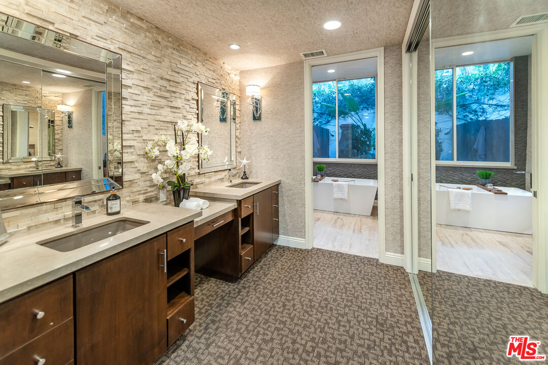 4500 Park Serena Calabasas, CA 91302 - Photo 20 of 34 a bathroom with a double vanity sink a mirror and a shower