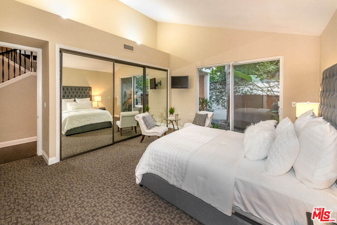 4500 Park Serena Calabasas, CA 91302 - Photo 22 of 34 a bedroom with a bed lamp and large window