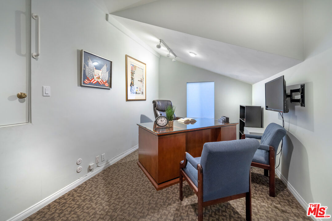 4500 Park Serena Calabasas, CA 91302 - Photo 25 of 34 a living room with furniture a flat screen tv and kitchen view