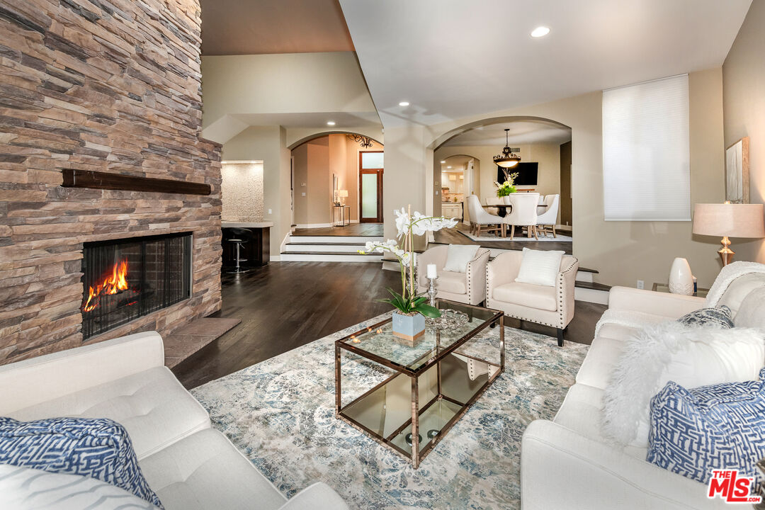 4500 Park Serena Calabasas, CA 91302 - Photo 7 of 34 a living room with furniture a fireplace and a dining table with fireplace