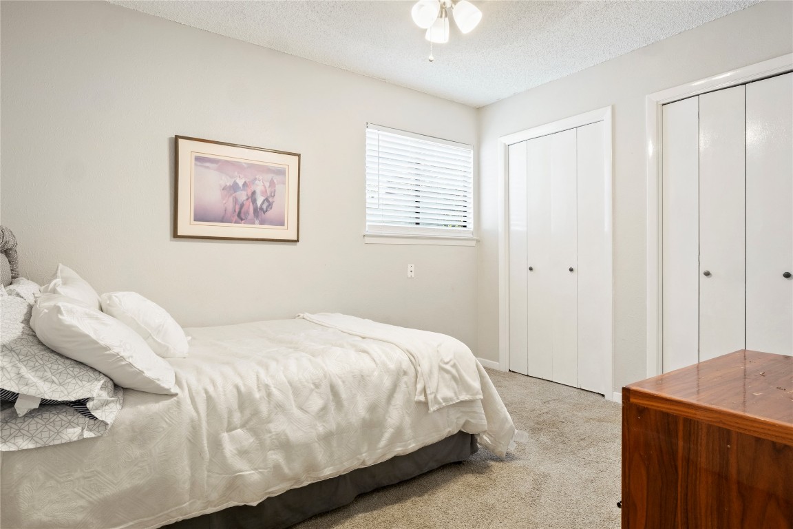 3222 Tamarron Boulevard, Unit A Austin, TX 78746 - Photo 14 of 28 a bedroom with a bed and a cabinets