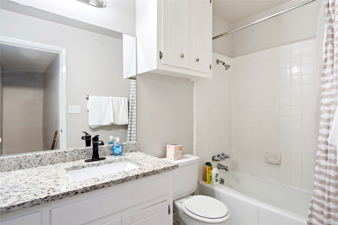 3222 Tamarron Boulevard, Unit A Austin, TX 78746 - Photo 15 of 28 a bathroom with a granite countertop sink toilet and shower