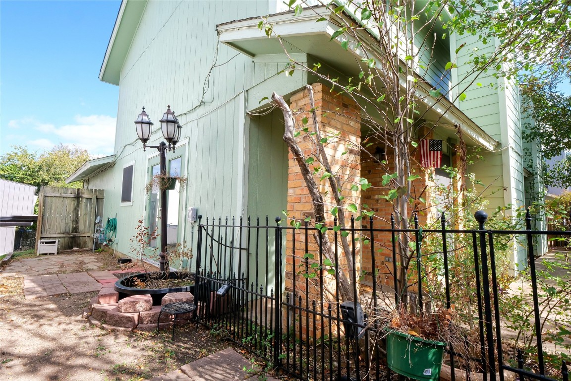 3222 Tamarron Boulevard, Unit A Austin, TX 78746 - Photo 16 of 28 a view of a brick house with a chairs and table in the patio