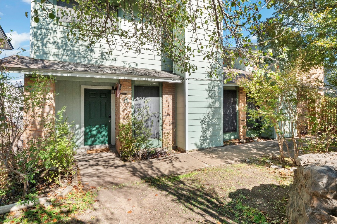 3222 Tamarron Boulevard, Unit A Austin, TX 78746 - Photo 2 of 28 a front view of a house with a garden