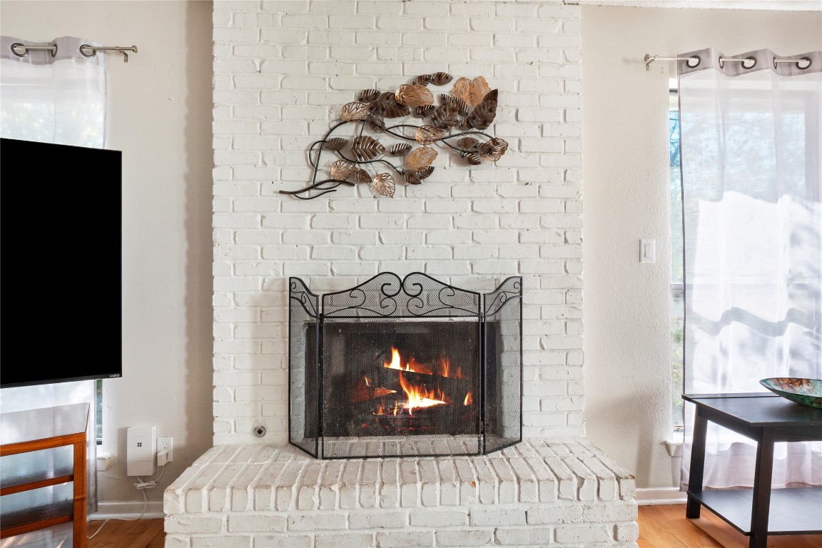 3222 Tamarron Boulevard, Unit A Austin, TX 78746 - Photo 6 of 28 a living room with furniture a fireplace and a flat screen tv