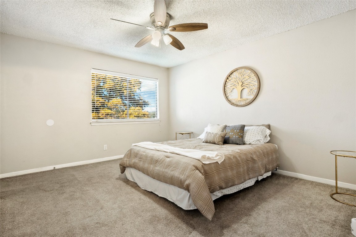 3222 Tamarron Boulevard, Unit A Austin, TX 78746 - Photo 10 of 28 a bedroom with a bed and a window