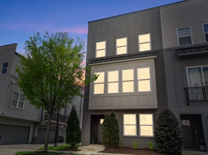 a view of building with a tree front of house