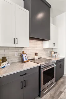 a bathroom with a granite countertop sink a toilet and shower