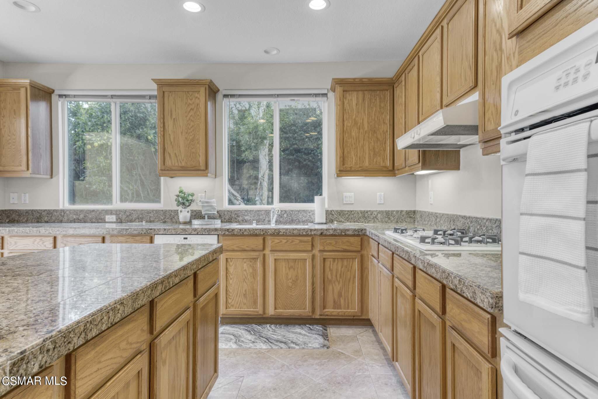 476 Woodland Road Simi Valley, CA 93065 - Photo 16 of 41 a kitchen with stainless steel appliances granite countertop a sink stove and cabinets