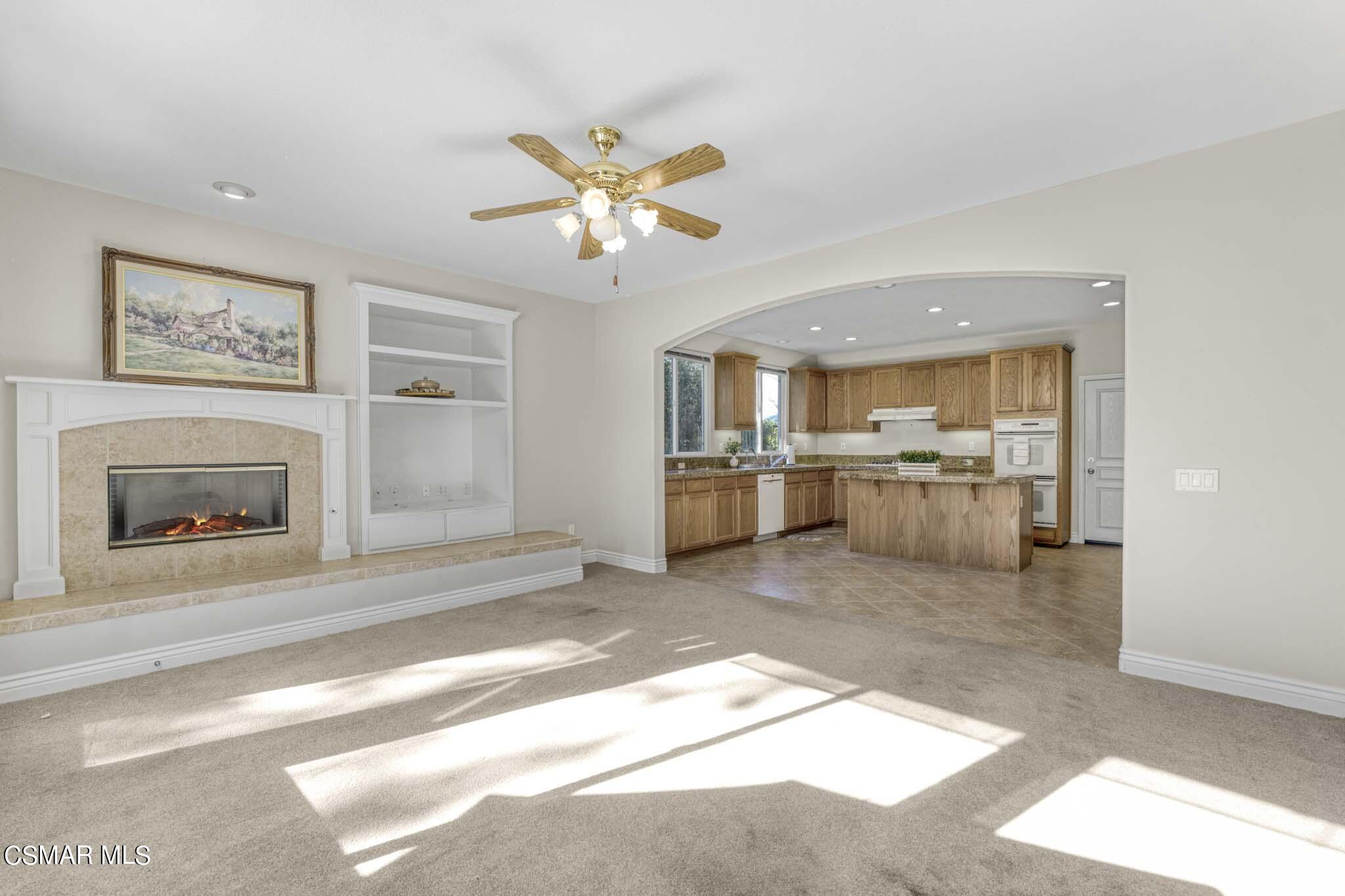 476 Woodland Road Simi Valley, CA 93065 - Photo 18 of 41 a view of a hallway with a kitchen and a fireplace