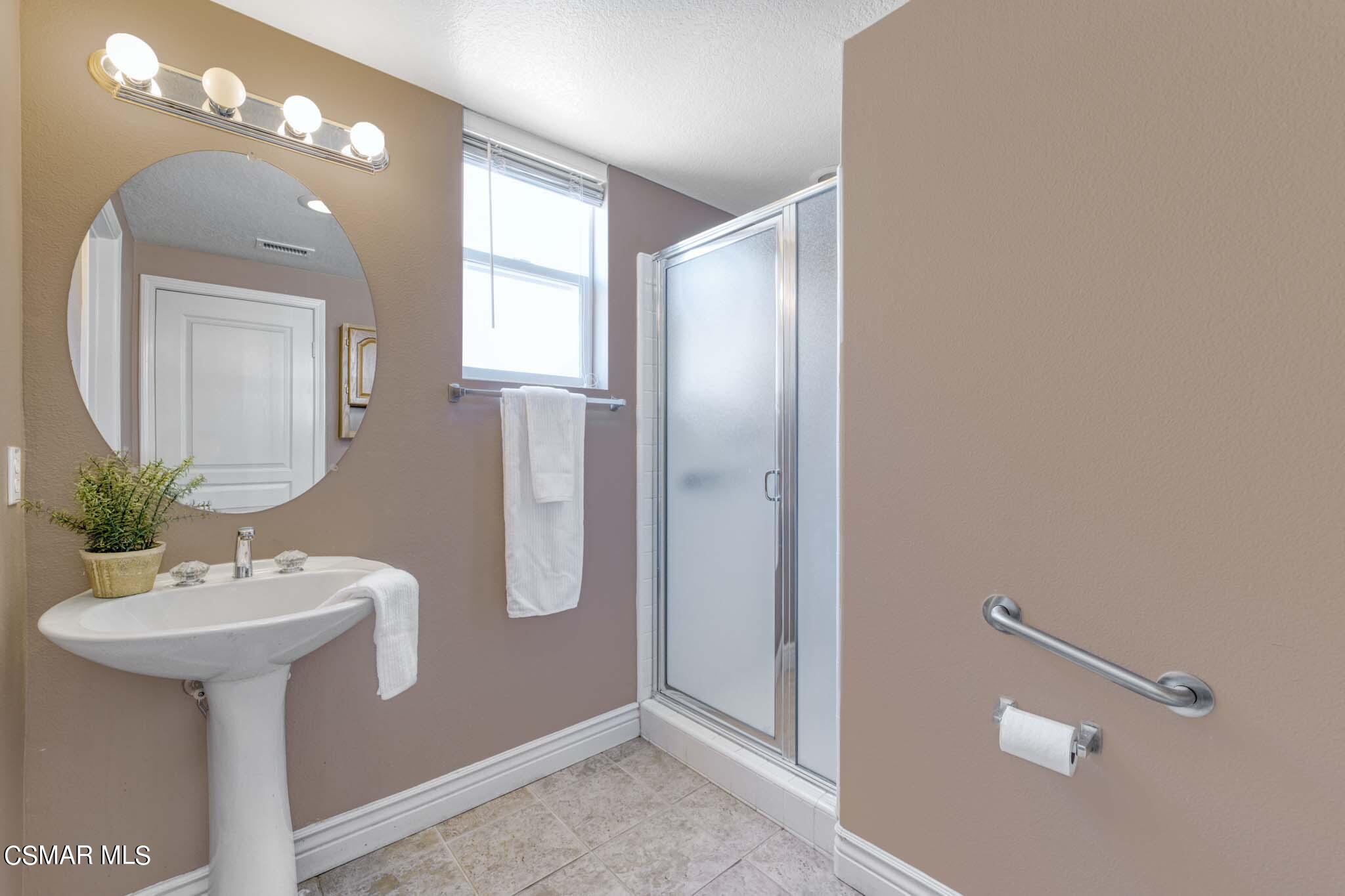 476 Woodland Road Simi Valley, CA 93065 - Photo 20 of 41 a bathroom with a sink a light fixture and a mirror