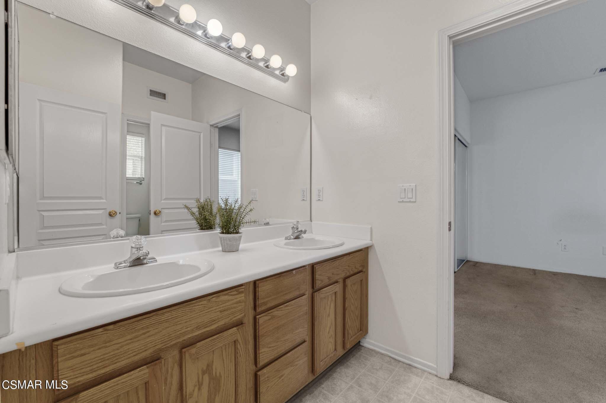 476 Woodland Road Simi Valley, CA 93065 - Photo 31 of 41 a bathroom with a sink double vanity and a mirror