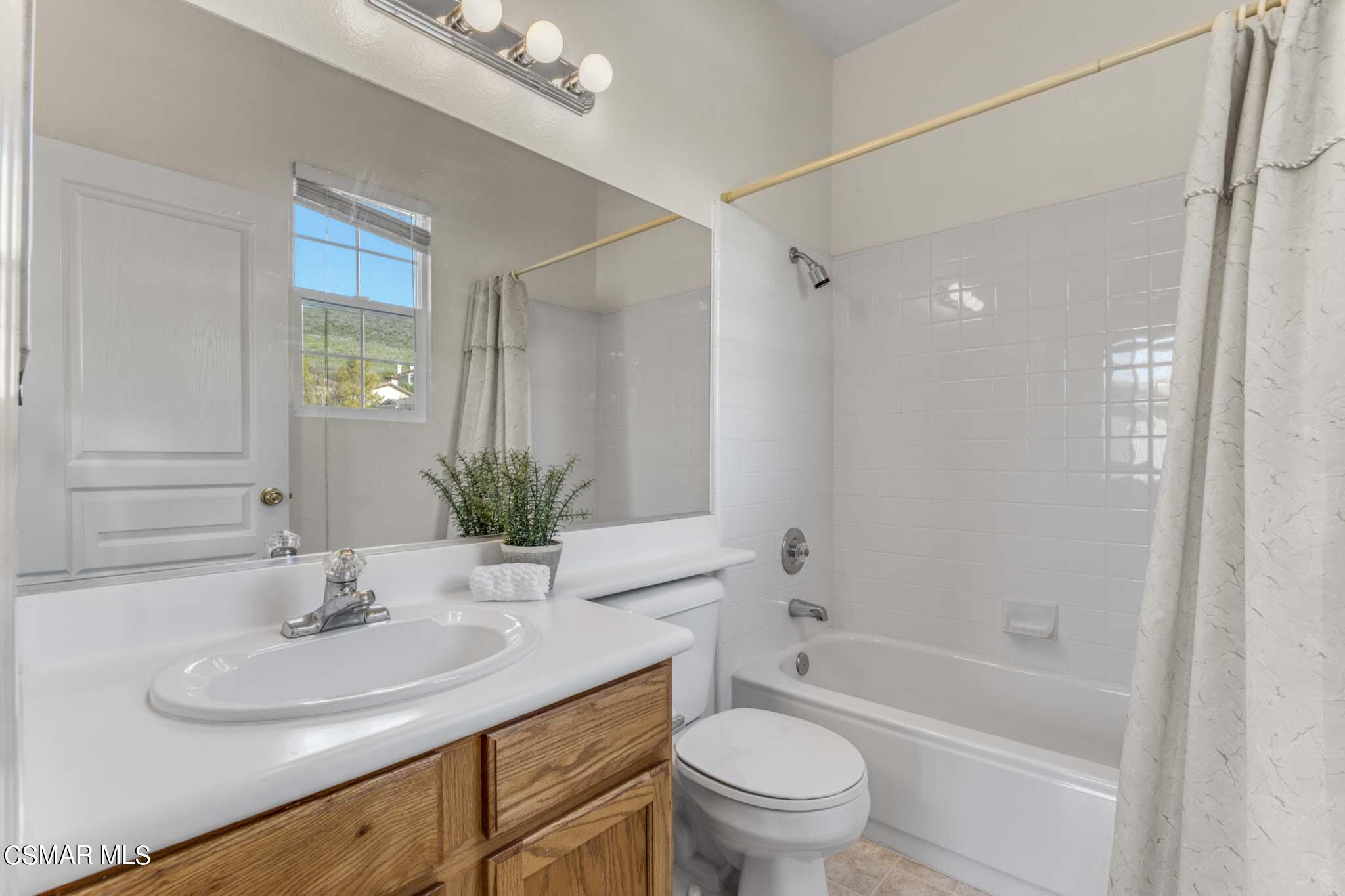 476 Woodland Road Simi Valley, CA 93065 - Photo 33 of 41 a bathroom with a granite countertop sink a toilet a mirror and shower