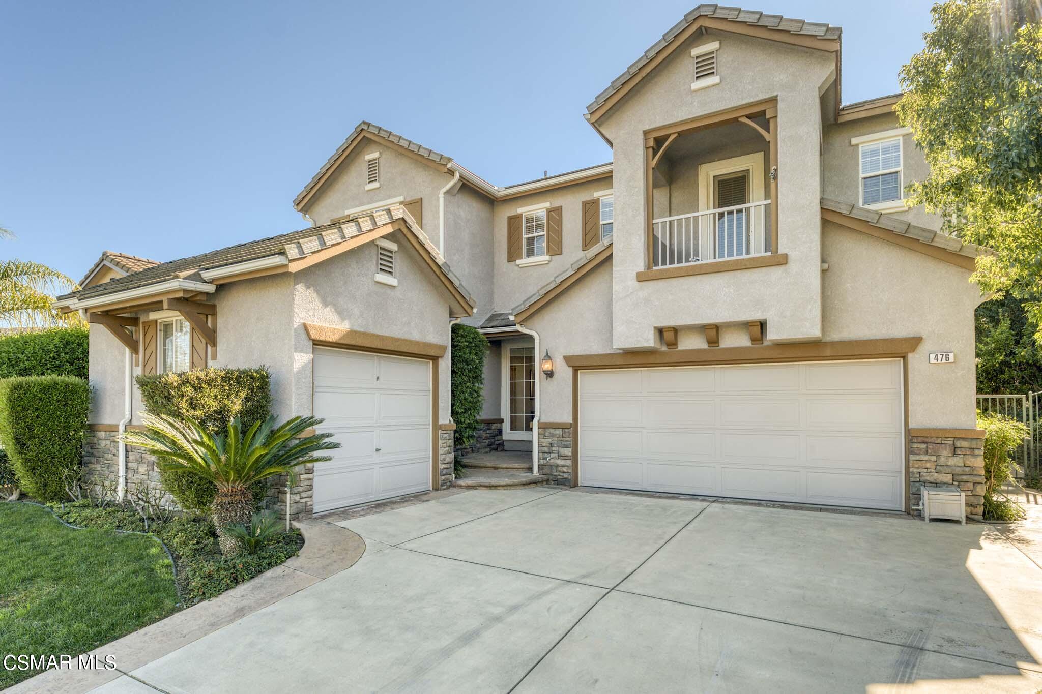 476 Woodland Road Simi Valley, CA 93065 - Photo 4 of 41 a front view of a house with a yard and garage