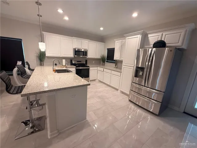 a kitchen with a sink appliances and cabinets