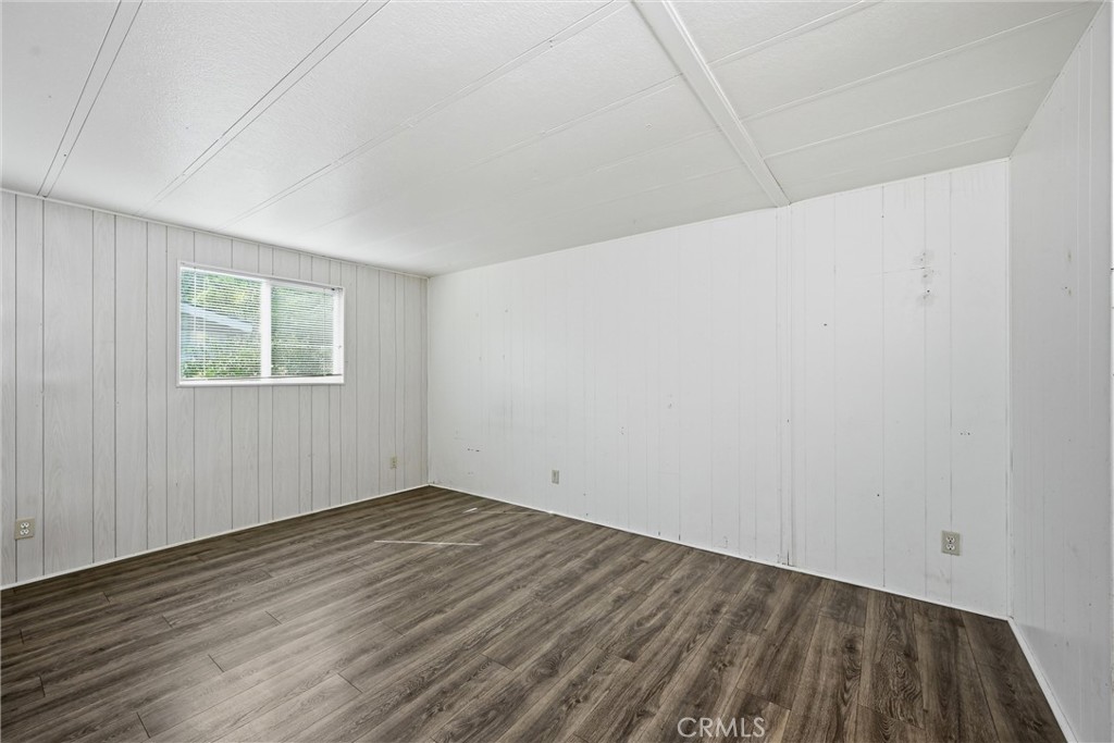 3795 Spring Valley Road Clearlake Oaks, CA 95423 - Photo 13 of 31 an empty room with wooden floor and windows