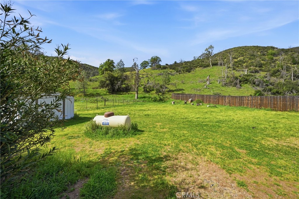 3795 Spring Valley Road Clearlake Oaks, CA 95423 - Photo 28 of 31 a view of a garden with a building in the background