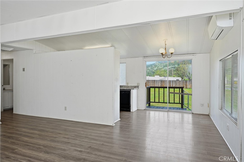 3795 Spring Valley Road Clearlake Oaks, CA 95423 - Photo 7 of 31 a view of an empty room with wooden floor and a window
